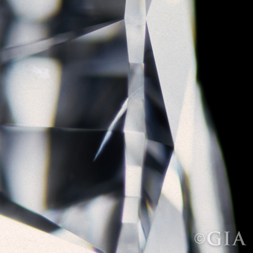 A photo of a pit. A type of diamond inclusion that looks like a jagged line.