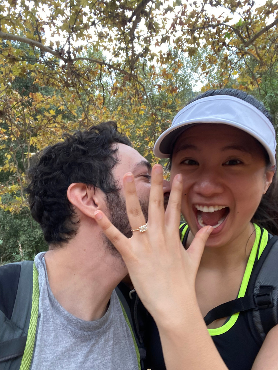 Woman wearing mason no. 2 frank darling custom east west emerald half bezel engagement ring