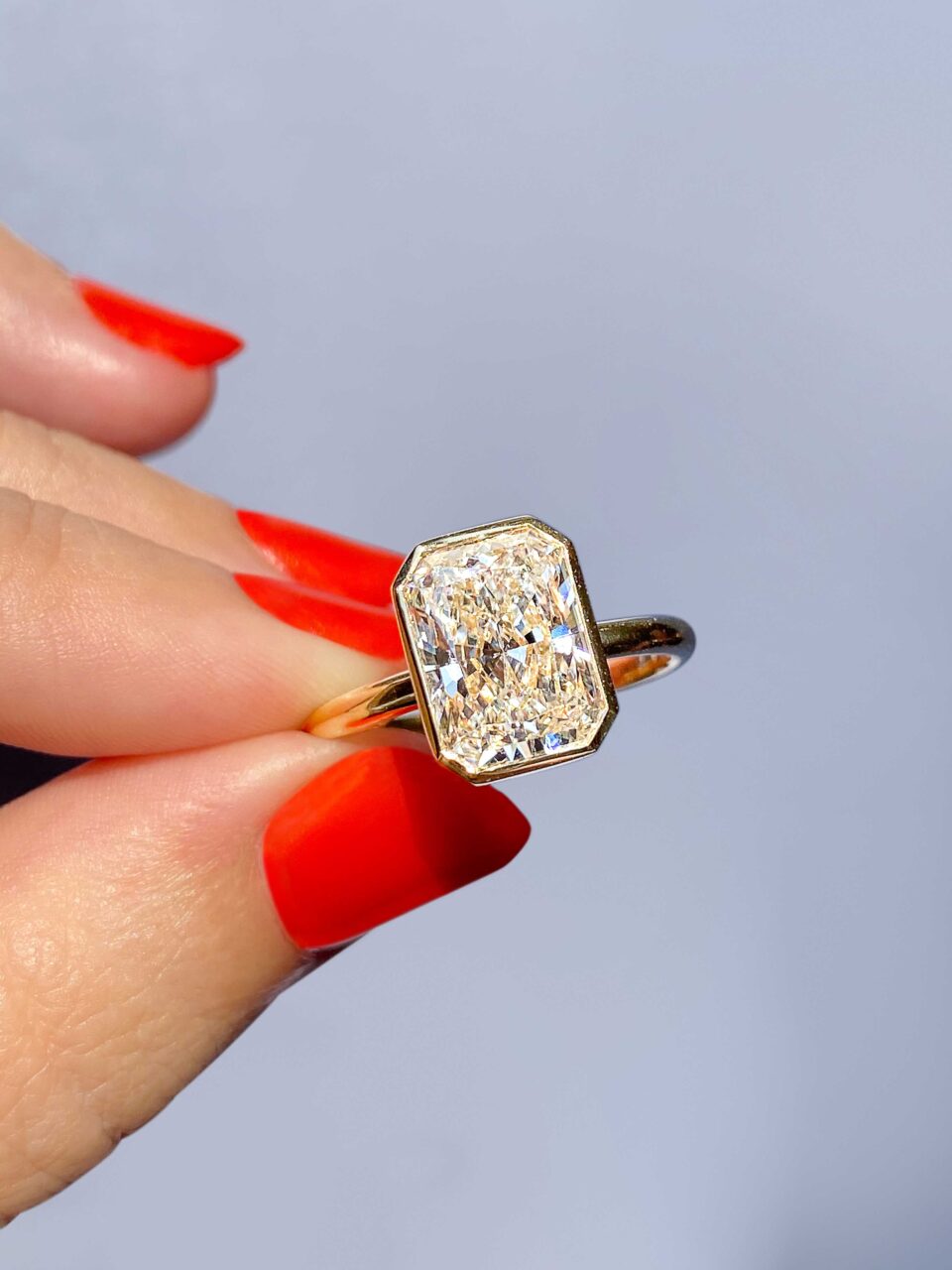 radiant cut lowrider bezel engagement ring