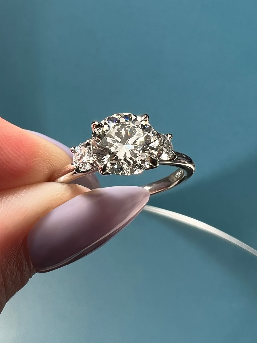 round diamond three stone engagement ring