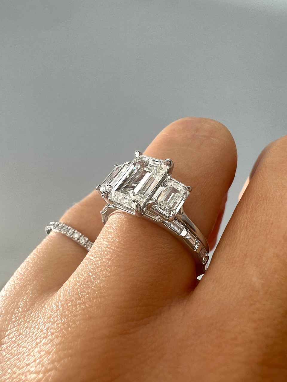 emerald cut three stone engagement ring